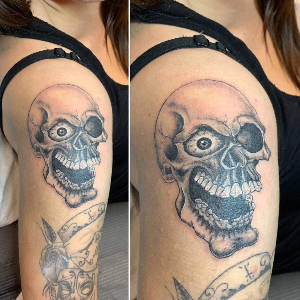 Smiling skull tattoo